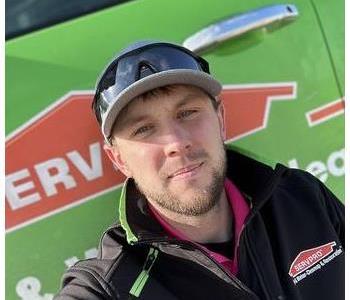 Operations manager in front of SERVPRO vehicle