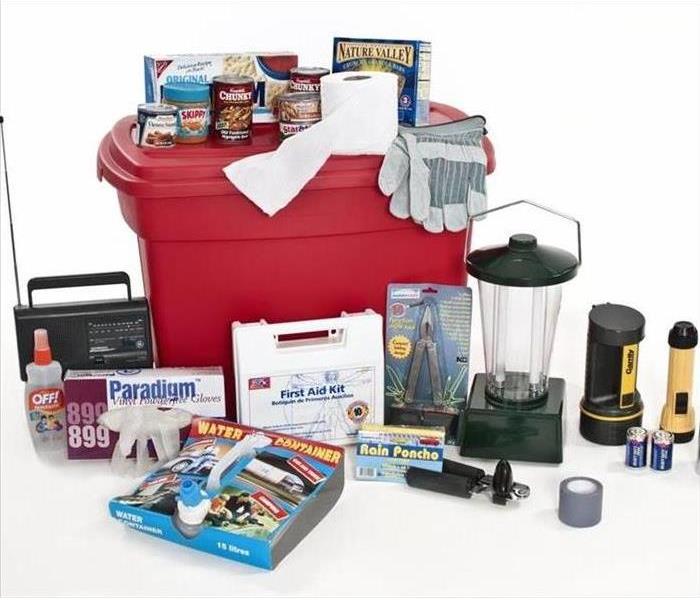 An emergency preparedness kit, with things like flashlights, first aid kit, and food and a radio.