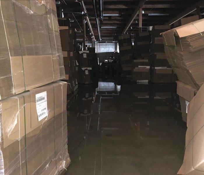 A Warehouse of boxes with water covering the floor